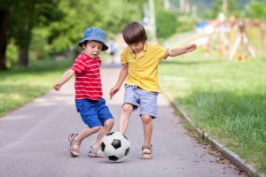 Two boys, playing football