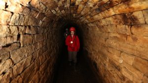 Young woman in the mine entrance