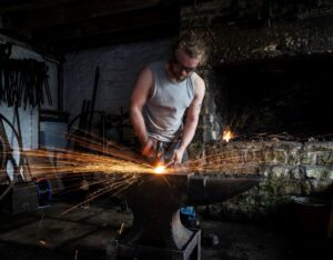 A blacksmith working at a forge