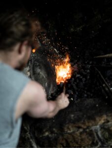 A blacksmith working a forge.